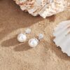 Earrings with Single Pearl surrounded by Floral Design