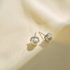 Silver earrings with pearls in wave design with stones