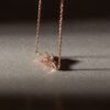Necklace designed with a leaf pendant adorned with gemstones.